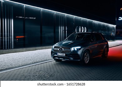 Katowice/Poland - 01.12.2020: Mercedes GLE parked next to a modern night-lit building