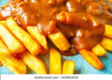 Katsu Curry Sauce With Onions On French Fries / Chips.