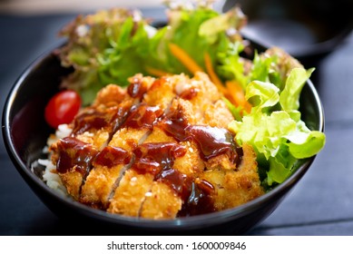 Katsudon In Black Bowl (deep Fried Pork Cutlet Dipped In Worcestershire Sauce On Rice). Japanese Food