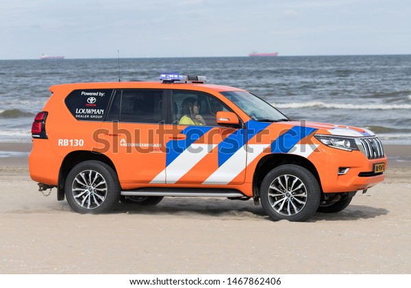 KATWIJK AAN ZEE, THE NETHERLANDS - JULY 6, 2019:\
Dutch lifeguard Toyota Land Cruiser with active blue emergency\
lighting on the beach