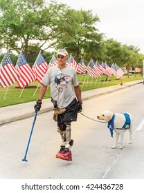 KATY, TEXAS-MAY 21, 2016: An Unidentified Senior US Veteran With Metal Legs And His Service Dog In The Running Race 5K Impac A Hero At Katy, Texas.