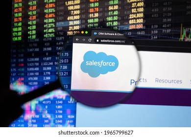 KAUFBEUREN, GERMANY - APRIL 26, 2021: Salesforce company logo on a website with blurry stock market developments in the background, seen on a computer screen through a magnifying glass.