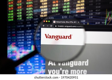 KAUFBEUREN, GERMANY - APRIL 26, 2021: Vanguard company logo on a website with blurry stock market developments in the background, seen on a computer screen through a magnifying glass.