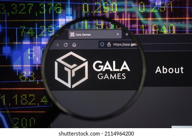 KAUFBEUREN, GERMANY - JANUARY 22, 2022. Gala crypto company logo on a website, seen on a computer screen through a magnifying glass.