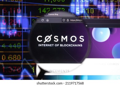 KAUFBEUREN, GERMANY - JANUARY 22, 2022. Cosmos Crypto Company Logo On A Website, Seen On A Computer Screen Through A Magnifying Glass.