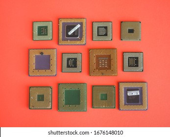 Kaunas / Lithuania - 03 14 2020: Underside Of Various CPUs On The Red Background. PGA (Pin Grid Array) And FCPGA (Flip Chip Pin Grid Array). Various Colors Ceramic And Organic Substrates. Bent Pins.