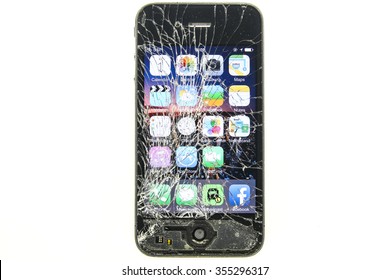 KAUNAS, LITHUANIA - DECEMBER, 26, 2015: Cracked screen smartphone. But still working. Broken iphone 4