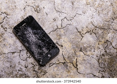 KAUNAS, LITHUANIA - FEBRUARY 8, 2016: Fallen on floor and broken smartphone. Screen cracked iphone