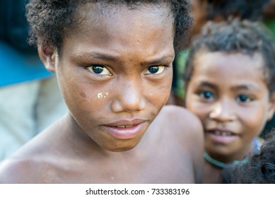 KAWA, TROBRIAND ISLANDS, PAPUA NEW GUINEA - NOVEMBER 13, 2016:  An unidentified indigenous tribal child living in poverty on a small island in the Trobriand Islands Papua New Guinea.