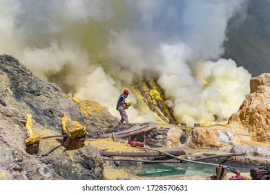 Kawah Ijen, Java, Indonesia - August 6, 2010: Sulfur Miner Carrying Sulfur Block At Kawah Ijen Volcano In East Java, Indonesia.