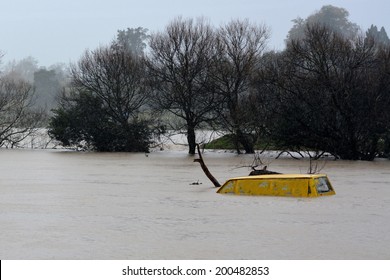 KAWAKAWA , NZL -JUNE10 2014:Submerge Car In A Flooded Road Near A River In Northland.Floods Are The Most Frequent And Costly Natural Disasters In New Zealand