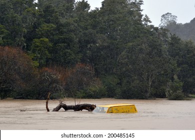 KAWAKAWA , NZL -JUNE10 2014:Submerge Car In A Flooded Road Near A River In Northland.Floods Are The Most Frequent And Costly Natural Disasters In New Zealand