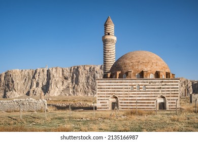 Kaya Celebi Cami mosque with Van Castle at background in Van city, Eastern Anatolia, Turkey. Ancient fortress of the Urartu Kingdom known as Tushba Castle in Van, eastern Turkey. Van Kalesi