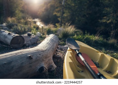 Kayak In Autumn Forest Near Riverbank