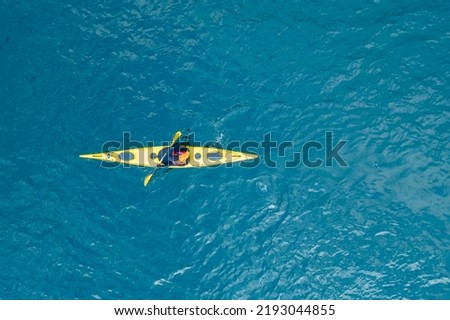 Kayak boat blue turquoise water sea, sunny day. Concept banner travel, aerial top view.