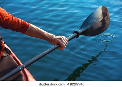Kayak Man's Hand Holding A Red Paddle