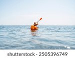 Kayak sea woman. Happy attractive woman with long hair in red swimsuit, swimming on kayak. Summer holiday vacation and travel concept.