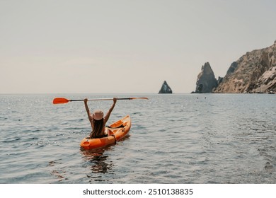 Kayak sea woman. Happy attractive woman with long hair in red swimsuit, swimming on kayak. Summer holiday vacation and travel concept.