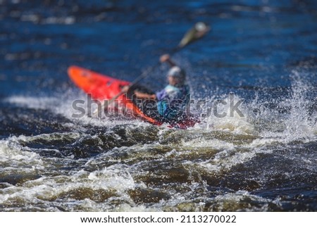 Kayak slalom canoe race in white water rapid river, process of kayaking competition with colorful canoe kayak boat paddling, process of canoeing with big water splash
