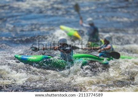 Kayak slalom canoe race in white water rapid river, process of kayaking competition with multiple colorful canoe kayak boat paddling, process of canoeing with big water splash