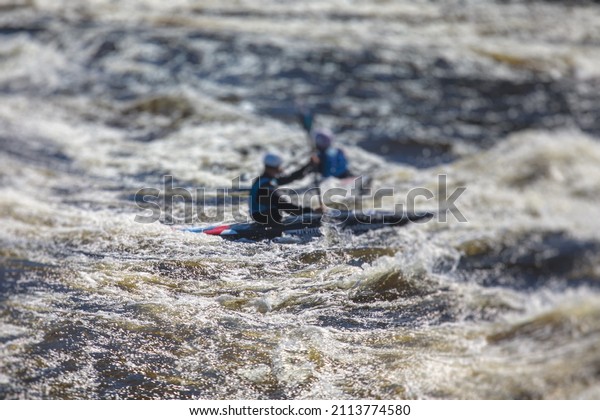 Kayak slalom
canoe race in white water rapid river, process of kayaking
competition with multiple colorful canoe kayak boat paddling,
process of canoeing with big water
splash
