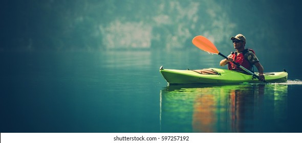 Kayak Water Sports Banner with Copy Space. Senior Kayaker on the Scenic Lake Panoramic Photo.