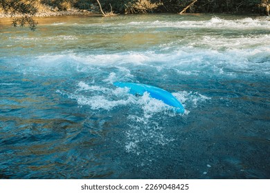 Kayaker capsized into the river while paddling. Flip and turn in a kayak.