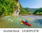 A kayaker is floating down the Buffalo River near Ponca, Arkansas. 