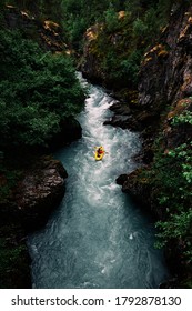 Kayaker Paddles Upstream In Green Gorge