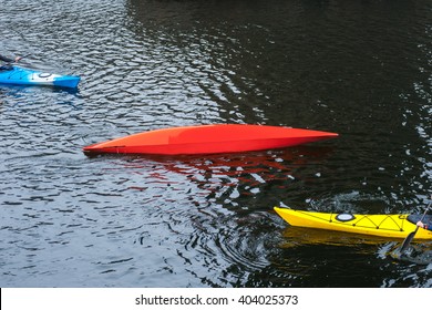 kayaker performs float-assisted roll,  Eskimo roll, kayaking