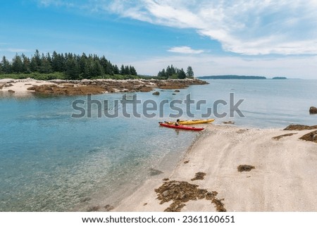 kayakers beached on the shore at Deer Isle, Maine