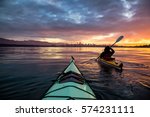 Kayakers enjoying the beautiful sunrise. Picture taken near Kitsilano Beach, Vancouver, BC, Canada.