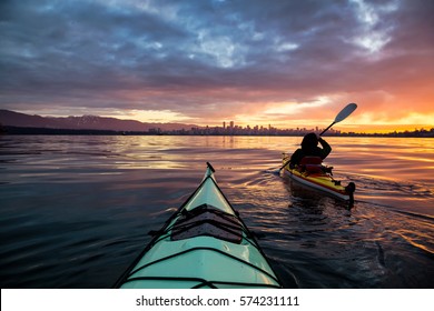 Kayakers enjoying the beautiful sunrise. Picture taken near Kitsilano Beach, Vancouver, BC, Canada. - Shutterstock ID 574231111