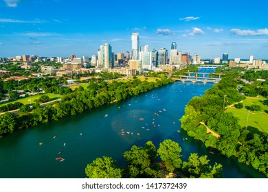 Kayakers Enjoying Summer Heat On Lady Bird Lake With Crowds Of People Below On The Water Austin Texas USA Downtown Skyline Cityscape At Sunset 2019