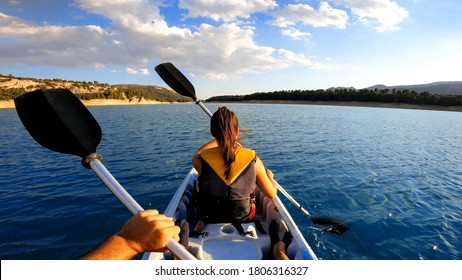 Kayakers Rowing At Lake. Pov Of Woman Kayaking In Beautiful Landscape At Embalse De La Bolera, Spain. Aquatic Sports In Kayak During Summer Concept.