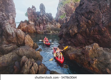 Kayaking, Adventure Travel, Group Of People On Kayaks Between Cliffs