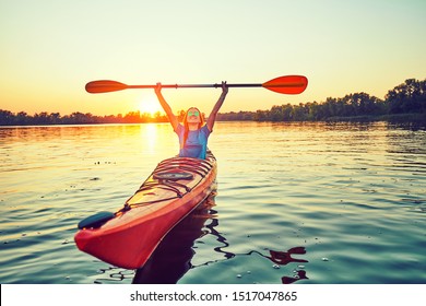 Kayaking couple ride along the river at sunset - Powered by Shutterstock