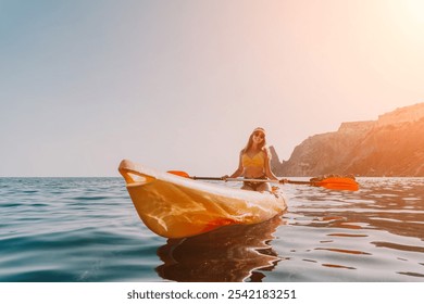 Kayaking, Ocean, Adventure: Woman Paddling Kayak on Calm Water with Rocky Cliffs in Background. - Powered by Shutterstock