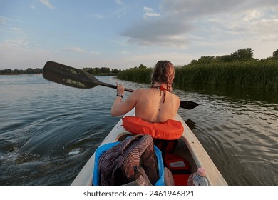 Kayaking on a Lake Tisza at dusk, motion blur on the paddle, view from inside the back of the kayak - Powered by Shutterstock