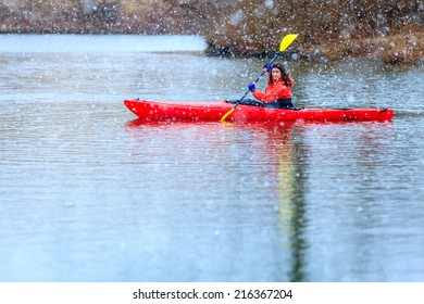 Kayaking On A Lake Under Heavy Snow