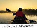 Kayaking on the river during sunrise, young man canoeing in Kavvayi Island Kannur, Kerala backwaters adventure activities 