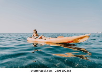 Kayaking Sea Woman Relaxing - Woman in a yellow kayak enjoying a relaxing day on the water. - Powered by Shutterstock