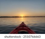 Kayaking at sunset in red kayak