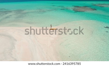 Kayaking wild tropical island sand beach coral reef. Woman relax enjoy active sport outdoor lifestyle travel on summer holiday vacation. Amazing nature sea landscape. Aerial drone view flight