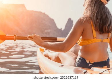 Kayaking Woman Mountains Water - A woman kayaks on a lake with mountains in the background. - Powered by Shutterstock