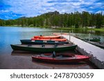 Kayaks and Canoes moored at Sylvan Lake Park in Custer State Park of the Black Hills, South Dakota, United States: Tranquil popular place for water sports, hiking, picnicking and rock climbing