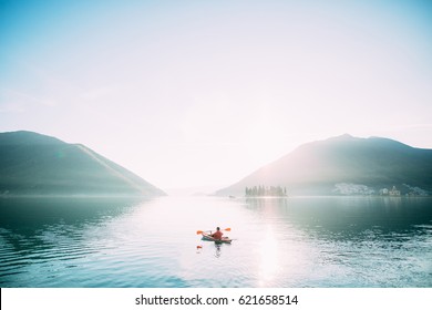 Kayaks in the lake. Tourists kayaking on the Bay of Kotor, near the town of Perast in Montenegro. Aerial Photo drone. - Powered by Shutterstock