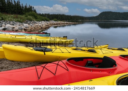 Kayaks on sandy beach of Newman Sound, Terra Nova National Park, Newfoundland, Canada. Red and yellow sea kayaks. 