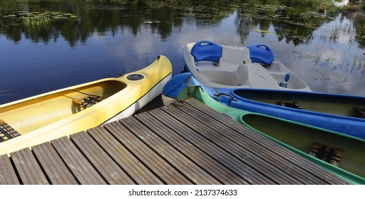 kayaks and pedal boats on a small lake