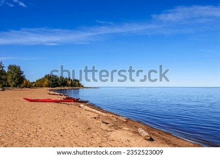 Kayaks pulled up on a sandy beach along the shore of Great Slave Lake in Canada's Northwest Territories